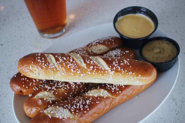 Large Soft Pretzels Soft pretzels with salt and dipping sauces dre stock pictures, royalty-free photos & images