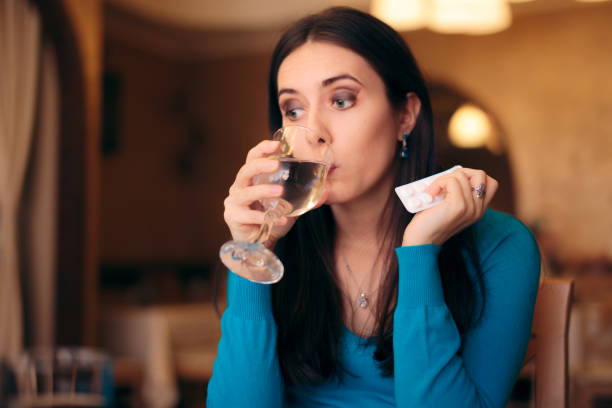 istock Woman Taking Her Pills in a Restaurant 1166315259