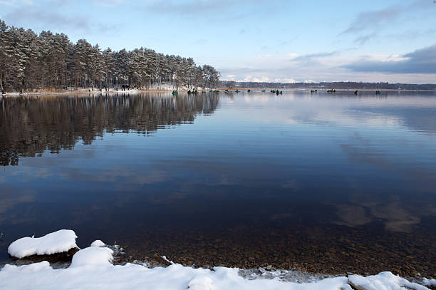 istock Winter lake and fishermen 116631536