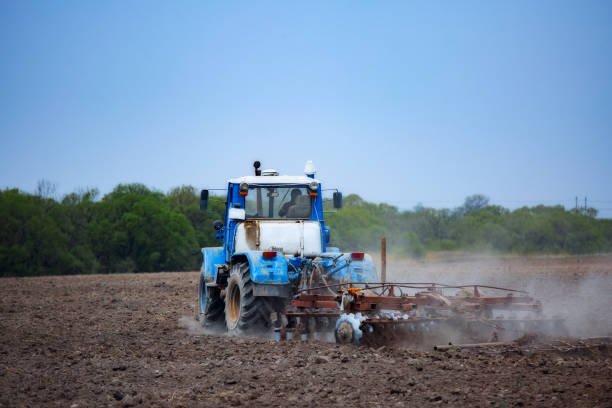 istock tractor plows the field with a plow 1166315868