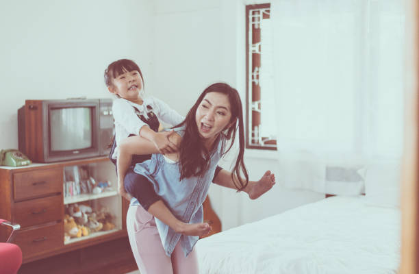 istock Single mom and daughter on a piggy back ride,Happy and smiling 1166316032