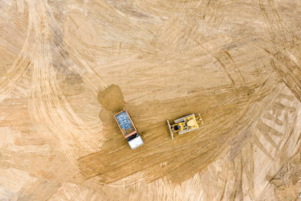 istock top view of track bulldozer leveling soil before road construction 1166318184