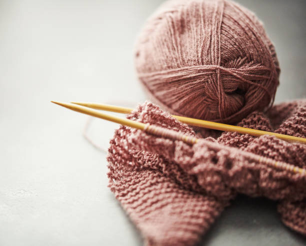 istock Knitting needles with pink knitting in progress 1166320127