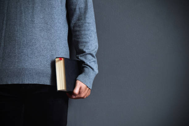 istock A young man is holding a black bible.Christians and Bible study concept.copy space 1166320863