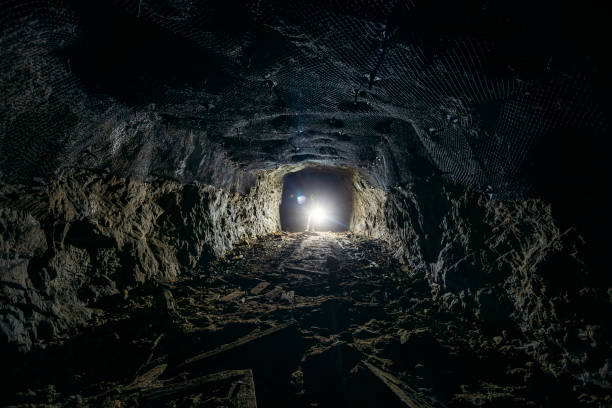 istock Dark dirty abandoned uranium mine with rusty remnants of railway 1166324047