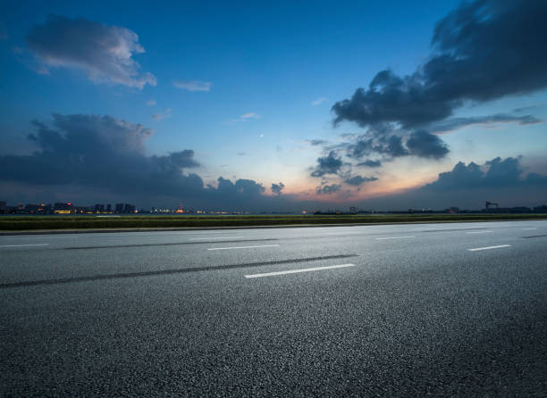 istock Empty asphalt road and blue sea nature landscape at sunset 1166325904
