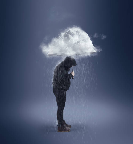 istock Holding an umbrella with a cloud ahead. 1166327138