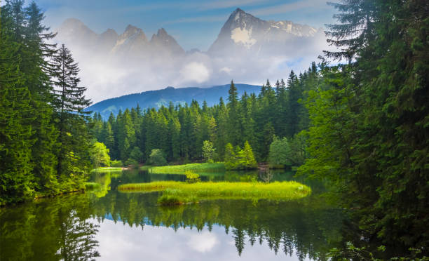 istock small lake among a snowbound mountain, beautiful mountain valley scene 1166330351