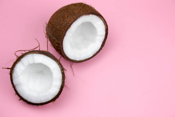 istock broken coconut on a pastel pink background copy space 1166331323