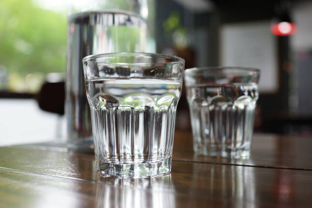 istock Glass of water on wooden table 1166332361