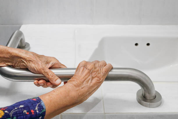 istock Elderly woman holding on handrail in bathroom 1166334847
