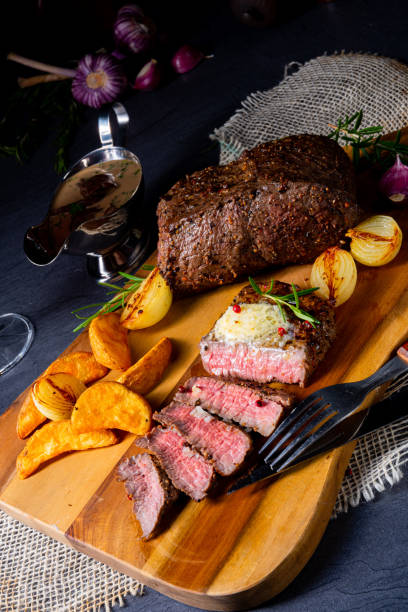 istock rustic medium butter beef steak with herbs and potato wedges 1166334860