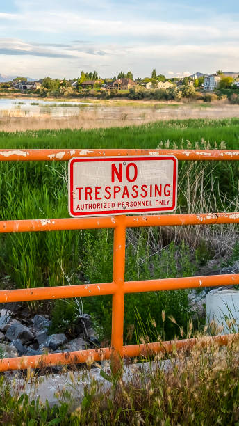 istock Vertical frame No Trespassing sign on an old metal railing with peeling orange paint 1166334901