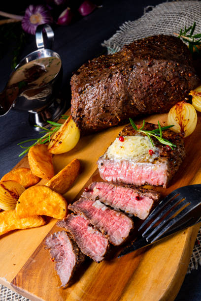 istock rustic medium butter beef steak with herbs and potato wedges 1166334929