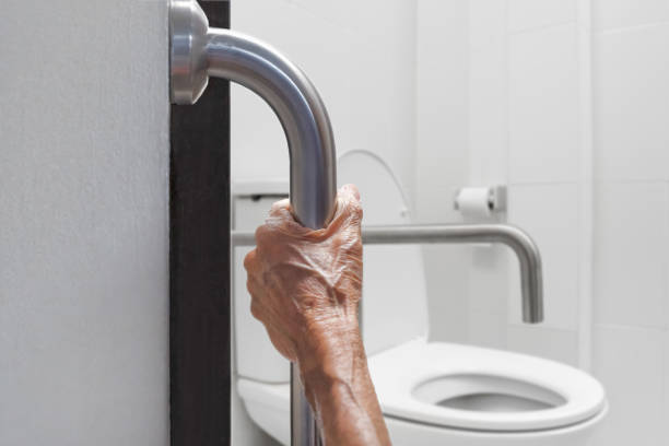 istock Elderly woman holding on handrail in bathroom 1166335048