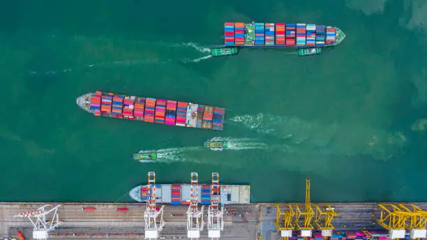 Photo of Aerial view cargo ship terminal, Unloading crane of cargo ship terminal, Aerial view industrial port with containers and container ship.