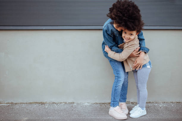 istock Sisters kissing and embracing 1166336896