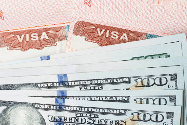 Stamp visa in the passport and american dollars close-up, top view Stamp visa in the passport and american dollars close up, top view one hundred dollar stamp stock pictures, royalty-free photos & images