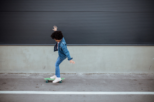Little girl having fun with skateboard