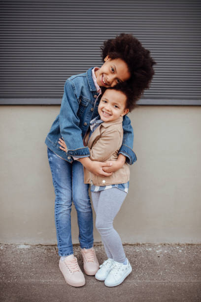 istock Sisters kissing and embracing 1166338055