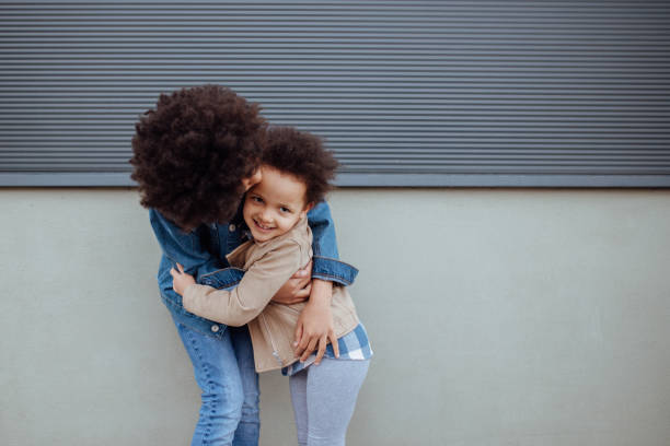 istock Sisters kissing and embracing 1166338534