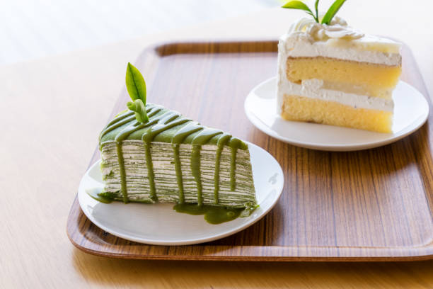 Green tea cake placed on a wooden plate stock photo