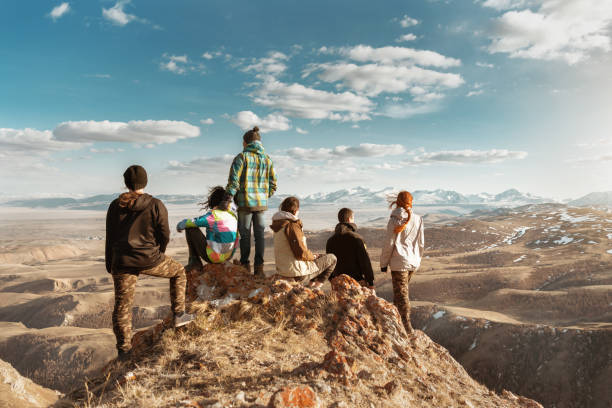 Group of tourists at mountains viewpoint Group of tourists or friends stands at viewpoint and looks at mountains altai nature reserve photos stock pictures, royalty-free photos & images