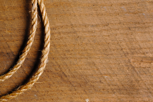 Photography of rope on textured wood background