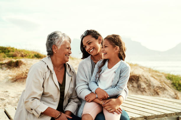 We see so much of ourselves in her Shot of an adorable little girl spending the day with her mother and grandmother at the beach three generation family stock pictures, royalty-free photos & images