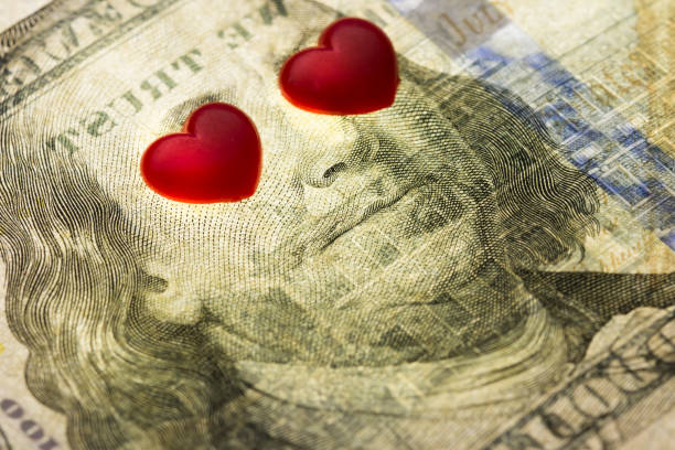 Hundred dollar banknote of usa. eyes of Franklin are closed by hearts .  Concept financial love and a gift for Valentine`s Day Hundred dollar banknote of usa. eyes of Franklin are closed by hearts .  Concept financial love and a gift for Valentine`s Day valentinstag stock pictures, royalty-free photos & images