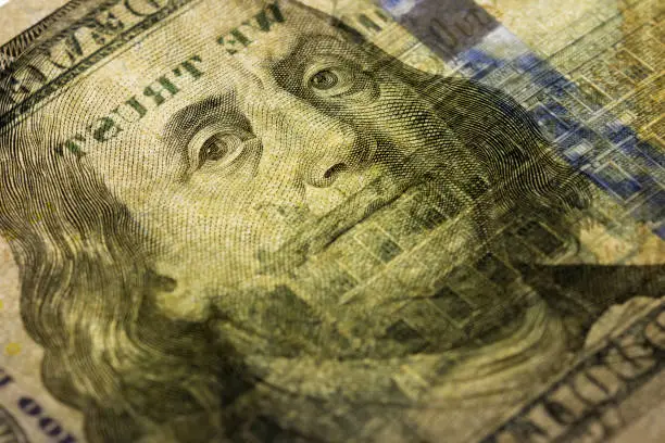 Photo of Close up view Portrait of Benjamin Franklin on the one hundred dollar bill. Cash background