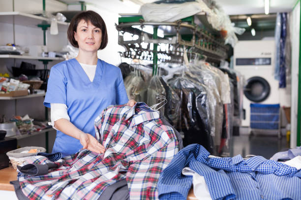 istock Girl laundry worker showing clean clothing 1166352914