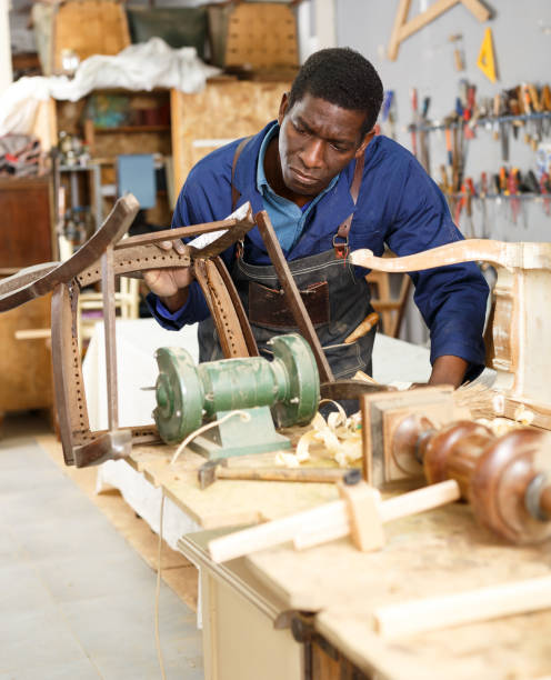 istock Craftsman restoring old chair in studio 1166353059