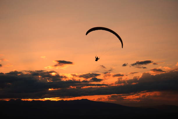 istock Parachute landing at sunset 1166353873