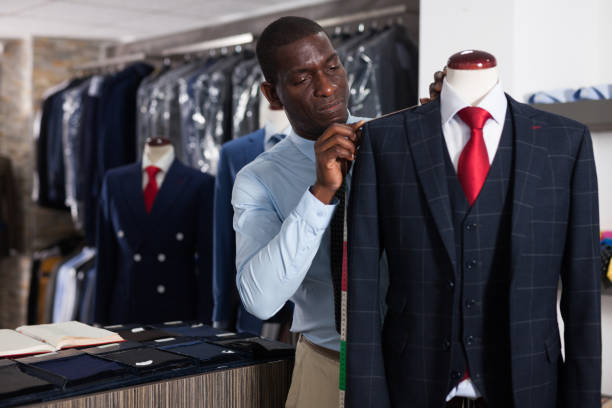 istock Tailor makes measurements of a business suit 1166355174