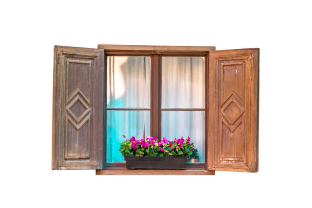 istock Old brown wooden window with flowers isolated on white background 1166355402