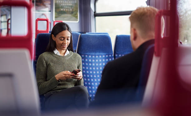 istock Female Passenger Sitting In Train Looking At Mobile Phone 1166357898