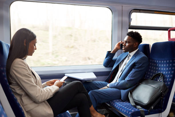 istock Business Passengers Sitting In Train Commuting To Work Using Mobile Phones 1166359906