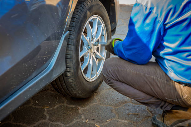istock Seasonal tyre replacement. Auto mechanic changing car wheel. 1166359934