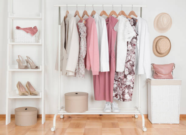 collection of female clothes hanging on rack in dressing room - home accessories imagens e fotografias de stock