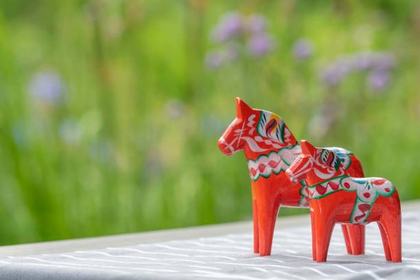 Dalecarlian Horse, (Dalahäst) . Traditional Swedish Symbol of Dalarna, Sweden. Yellow hand painted wooden statue of a horse.