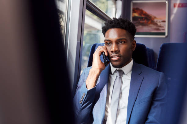 istock Businessman Sitting In Train Commuting To Work Making Call On Mobile Phone 1166361784