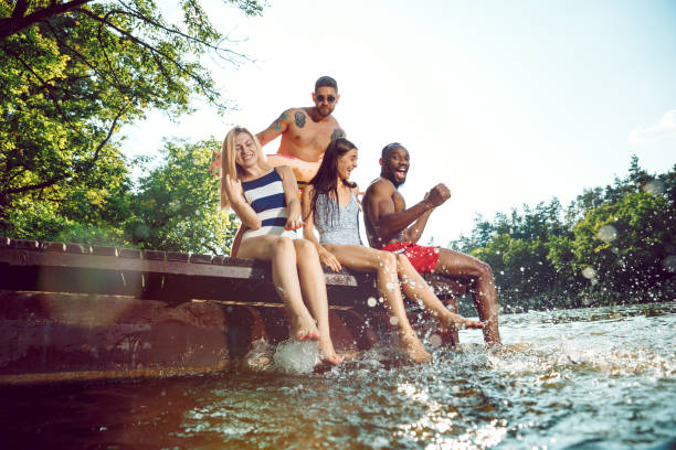 istock splashing water and laughting on the pier on river 1166362022