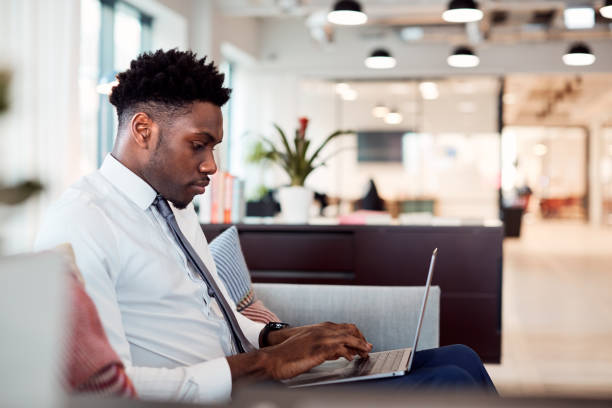 istock Businessman Working On Laptop At Desk In Shared Workspace Office 1166363424