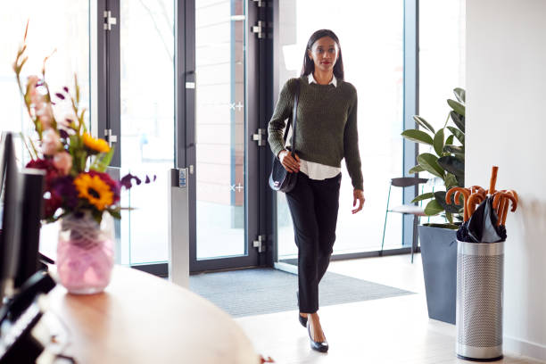 Businesswoman Arriving For Work At Office Walking Through Door Businesswoman Arriving For Work At Office Walking Through Door day 1 stock pictures, royalty-free photos & images