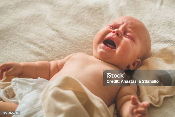 Crying Hungry Newborn Baby Lying On The Bed Love Baby Newborn Baby And Mother Stock Photo - Download Image Now