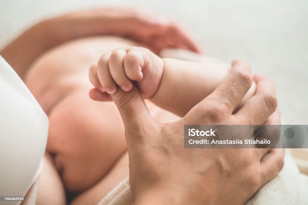 Portrait of a mom and breast feeding baby. Concept breast feeding Portrait of a mom and breast feeding baby. Concept breast feeding. Breastfeeding Stock Photo