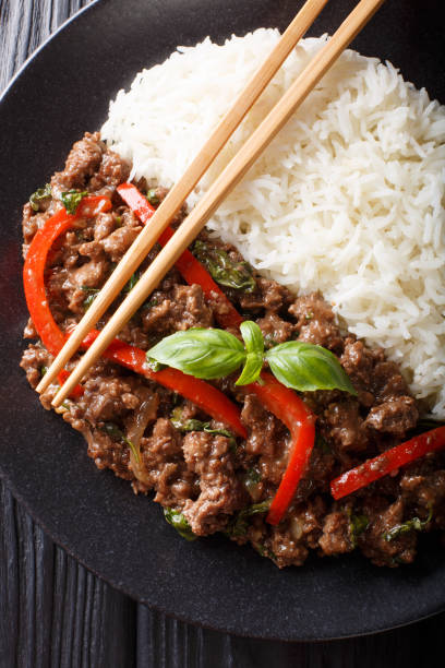 istock Thai Basil Beef, or Pad Gra Prow with rice side dish close-up. Vertical top view 1166366065