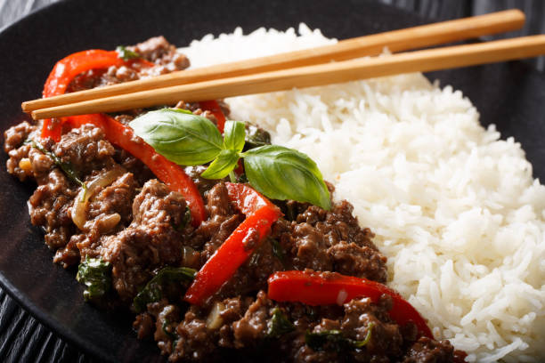 istock basil beef with bell pepper in a spicy sauce served with rice close-up on a plate. horizontal 1166366110