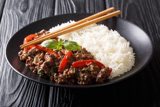 istock Traditional Thai Basil Beef, or Pad Gra Prow over white rice closeup on a plate. horizontal 1166366120